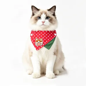 Close-up of double-sided pet triangular bib with cute dog embroidery and red polka dots.