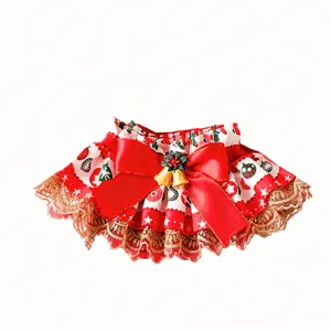 Christmas pet collar detail view, featuring red satin bow, gold bells and delicate lace trim.