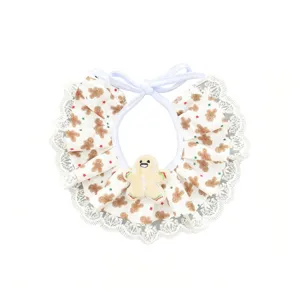 Cute Christmas pet bib with gingerbread man print and white lace trim for dogs and cats.