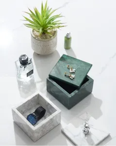 Detailed view of modern natural marble jewelry storage box and tray set for home decor display.