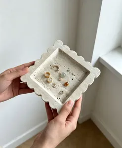 Scalloped travertine stone tray with natural texture, perfect for jewelry, keys, and home decor display.