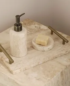 Detailed view of natural travertine tray with metal handles, luxury bathroom organizer.
