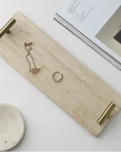 Detailed shot of luxury natural travertine tray with metal handles, perfect for desktop decor.