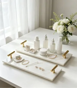 Detailed view of white marble storage tray featuring luxury gold handles and chic design.