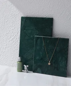 Green natural marble flat plate photography prop for jewelry and cosmetics display details.