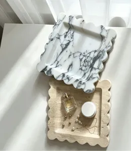 Detailed view of luxury natural marble and travertine scalloped trays for home decor.