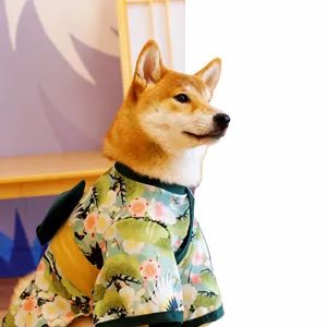 Pet dog wearing Japanese kimono outfit detail shot, floral pattern fabric closeup view.