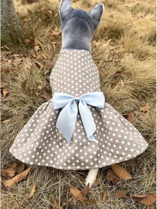Detail view of brown polka dot pet dress with blue bow, designed for cute dogs and cats.