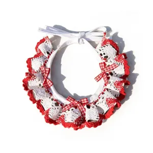 Closeup details of handmade red and white crochet pet collar bib with cute checkered bows.