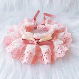 Pink lace pet bib close-up, delicate frilly lace trim and cute satin ribbon bow detail.