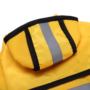 Détail de capuche imperméable pour chien jaune avec bordure noire et bande réfléchissante.