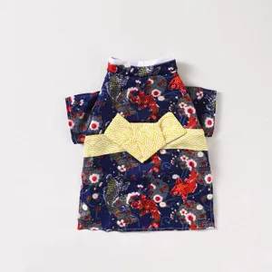 Close-up detail view of Japanese style pet kimono featuring vibrant koi fish and cherry blossom print.