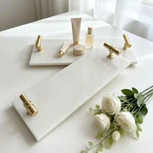 Luxury white marble vanity tray with elegant gold handles for perfume and cosmetics display.