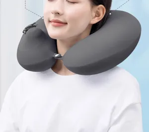 Ergonomic push-to-inflate U-shaped travel neck pillow in dark gray for comfortable flights.
