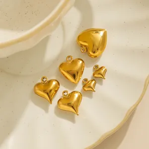 Close-up view of shiny gold stainless steel heart charms, perfect for DIY jewelry making accessories.