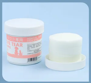 Detailed close-up view of white round pet tear stain wipes neatly stacked beside container.