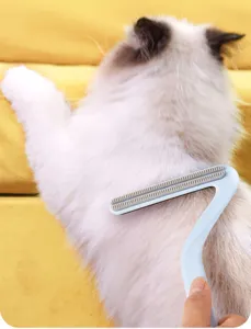 Pet hair removal comb detail view showing double-sided grooming tool cleaning cat fur effectively.