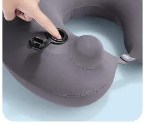 Inflatable neck pillow detail showing manual air pump valve and soft grey fabric design.