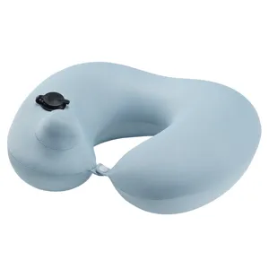 Light blue press-to-inflate travel neck pillow, portable and comfortable for flights and cars.