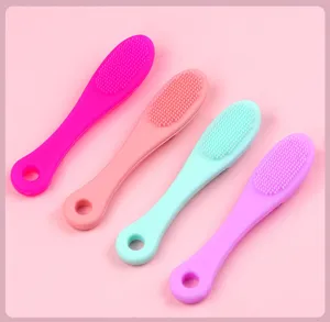 Silicone pet toothbrush detail view, soft dual-sided bristles in assorted colors.
