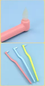 Pet toothbrush oral cleaning tool for cats and dogs with soft pointed bristles and angled handle.