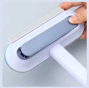 Multi-functional pet hair removal brush with long handle and scraper for easy cleaning.