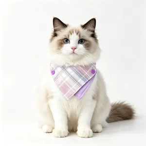 Close-up detail shot of a cute cat wearing a double-sided plaid pet bandana with snap buttons.