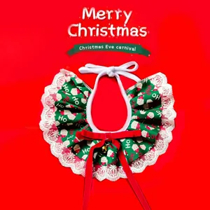 Close-up of Christmas pet bib with green Santa print, white lace edge and red bow detail.