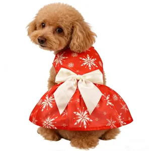 Detail view of Christmas pet dress, red snowflake print and white bow for cute dogs and cats.