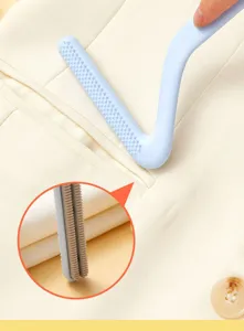 Double-sided pet hair removal brush for clothes and bedding, easy and efficient tool.