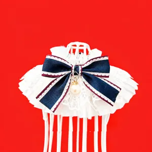Detailed view of French lace pet bib, cotton dog scarf featuring a chic bow and pearl pendant.