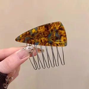 Detailed shot of the blue-brown acetate triangular hair comb, elegant side clip for styling.