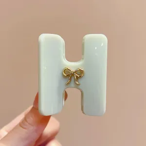 Molla per capelli in acetato a forma di H stile coreano con fiocco dorato elegante.