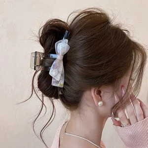 Elegante molletta per capelli con fiocco in acetato, perfetta per acconciature chic.