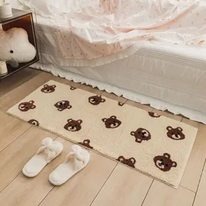 Close-up detail of the cute brown bear pattern bedside rug, soft plush texture bedroom mat.