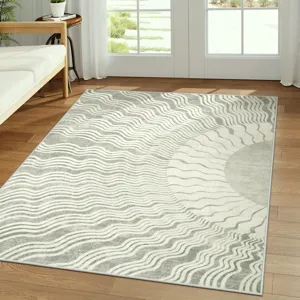 Modern abstract wave sun pattern area rug in grey and white, cozy living room decor detail.