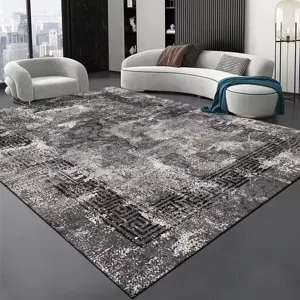 Detailed view of modern minimalist grey living room area rug with abstract geometric pattern.