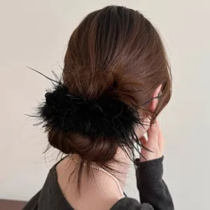 Black feather hair clip detail view, fluffy banana clip for elegant hairstyles, trendy accessory.
