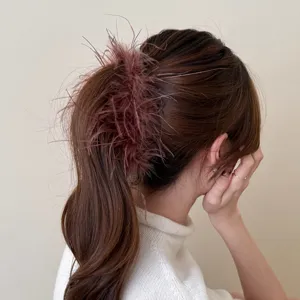 Elegant feather hair claw clip for women, stylish brown ponytail banana clip, chic hair accessory.