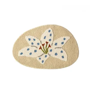 Close-up detail of soft tufted floral area rug with blue polka dot pattern and cozy texture.