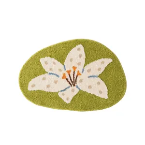 Detailed view of the soft tufted green lily flower rug, showing delicate texture and vibrant floral design.