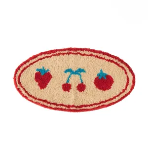 Cute fruit pattern tufted oval rug detail, soft plush bedroom bedside floor mat surface.