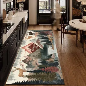 Detailed shot of a long kitchen runner rug with a scenic mountain and deer pattern in a home.