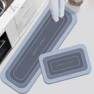 Absorbent diatomite kitchen floor mat two-piece set with anti-slip backing for home use.