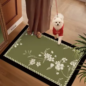 Green floral floor mat detail showing elegant white branch pattern and checkered border design.