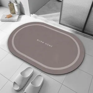 Tapis de bain ovale absorbant et antidérapant pour salle de bains et cuisine minimaliste.
