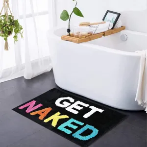 Detailansicht des lustigen schwarzen Badteppichs mit buntem GET NAKED Tufting Text.