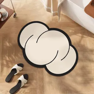 Detailed view of the abstract irregular cloud floor mat with chic black border design.