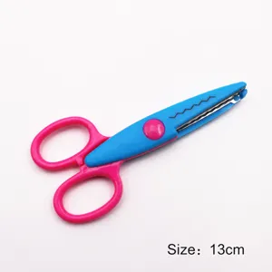 Detail view of craft scissors with wavy blade, plastic handle, and compact size for handmade DIY.