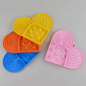 Silicone pet slow feeder lick mat for dogs and cats, heart-shaped anti-choking bowl with suction cups.